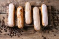 Coffee eclairs over wood Royalty Free Stock Photo