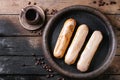 Coffee eclairs over wood Royalty Free Stock Photo