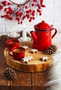 Coffee in enameled red cups and a red coffee pot