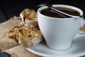 Coffee cup on dark wood background, with cantucci cookies Royalty Free Stock Photo