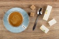 Coffee espresso in cup on saucer, sugar, spoon, nougat with marmalade on table. Top view Royalty Free Stock Photo