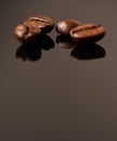 Coffee is everyones best friend. Studio shot of coffee beans against a brown background. Royalty Free Stock Photo