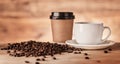 Coffee is everyones mutual best friend. Closeup shot of a paper cup and teacup surrounded by coffee beans. Royalty Free Stock Photo