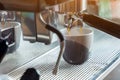 Coffee extraction from professional coffee machine. coffee machine preparing fresh coffee and pouring into cups at restaurant, bar Royalty Free Stock Photo