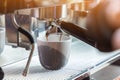 Coffee extraction from professional coffee machine. coffee machine preparing fresh coffee and pouring into cups at restaurant, bar Royalty Free Stock Photo