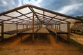 Coffee farm drying beans on trays in hangar with foof Royalty Free Stock Photo