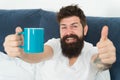 Coffee fills you with energy. Good gay begins from cup of coffee. Coffee affects body. Man handsome hipster relaxing on