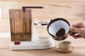 Old coffee machine and poured into a cup, decorated with roasted coffee beans Royalty Free Stock Photo