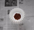 A coffee filter is holds a small mound of fresh roasted coffee beans, ready to be ground and brewed Royalty Free Stock Photo