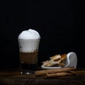 Coffee with foam in a small tube glass on a wood.Coffee with foam in a small tube glass on a wood Royalty Free Stock Photo