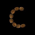 Coffee font alphabet concept isolated on white background. Top view Alphabet made of roasted coffee beans. Letter C