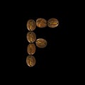 Coffee font alphabet concept isolated on white background. Top view Alphabet made of roasted coffee beans. Letter F