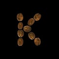 Coffee font alphabet concept isolated on white background. Top view Alphabet made of roasted coffee beans. Letter K