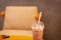 Coffee Frappuccino Blended with paper straw on wood table.