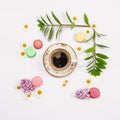 Coffee, french cookies macaroons, spring flowers