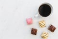 Coffee and French fondant cakes on white marble background