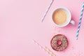 Coffee and fresh pastry of chocolate donut on pink pastel table top view. Flat lay. Cozy breakfast.