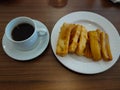 Coffee and frie banana on wooden table