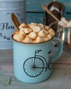 Coffee with generously sprinkled marshmallows and chocolate closeup on a wooden table