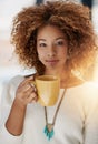 Coffee gets the day moving. Portrait of a young woman drinking a cup of coffee. Royalty Free Stock Photo