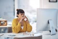 Coffee gives me the energy to get through the day. an attractive young businesswoman sitting in her office and enjoying