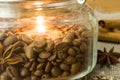 Flame of a candle in roasted coffee beans