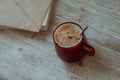 Coffee in a glass cup and morning mail stand on a wooden table.