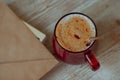 Coffee in a glass cup and morning mail stand on a wooden table.