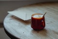 Coffee in a glass cup and morning mail stand on a wooden table.