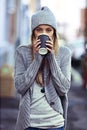 Coffee on the go. Portrait of a beautful young woman drinking coffee while out in the city.