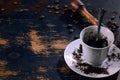 Coffee grains and a cup with coffee grounds on a plate on a background of an old board Royalty Free Stock Photo