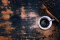 Coffee grains and a cup with coffee grounds on a plate on a background of an old board top view Royalty Free Stock Photo