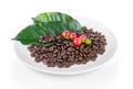 Coffee grains and leaves in plate on white background Royalty Free Stock Photo