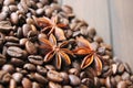 coffee grains and star anise on a wooden table, brown abstract background, warm texture, macro