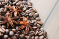 coffee grains and star anise on a wooden table, brown abstract background, warm texture, macro Royalty Free Stock Photo