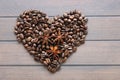 coffee grains and star anise on a wooden table, brown abstract background, warm texture, macro