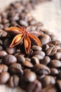 coffee grains and star anise on a wooden table, brown abstract background, warm texture, macro Royalty Free Stock Photo