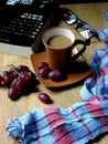 Coffee and grapes on a wooden table Royalty Free Stock Photo