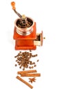 Coffee grinder with coffee beans and spices and spices cinnamon sticks, star anise on white background Royalty Free Stock Photo