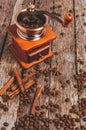Coffee grinder with coffee beans and spices and spices cinnamon sticks, star anise on a wooden background Royalty Free Stock Photo