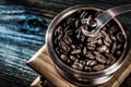 Coffee grinder beans on wooden board Royalty Free Stock Photo