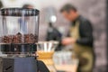 Coffee grinder with blurred barman in the background Royalty Free Stock Photo