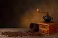 coffee grinder and clay cup on wooden table