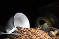 Coffee grinder with cup and coffee beans.