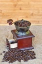 Coffee grinder full of roasted coffee beans - wooden background Royalty Free Stock Photo