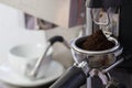 Coffee grinder grinding freshly roasted coffee beans
