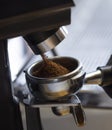 Coffee grinder grinding coffee pouring into a portafilter Royalty Free Stock Photo