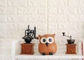 Coffee Grinder with owls statue against brick wall background. Not sleep like owls Concept