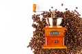 Coffee grinder on a pile of coffee beans. Coffee beans isolated on white background. Old wooden coffee grinder and aromatic beans Royalty Free Stock Photo