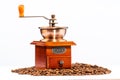 Coffee grinder on a pile of coffee beans. Coffee beans isolated on white background. Old wooden coffee grinder and aromatic beans Royalty Free Stock Photo